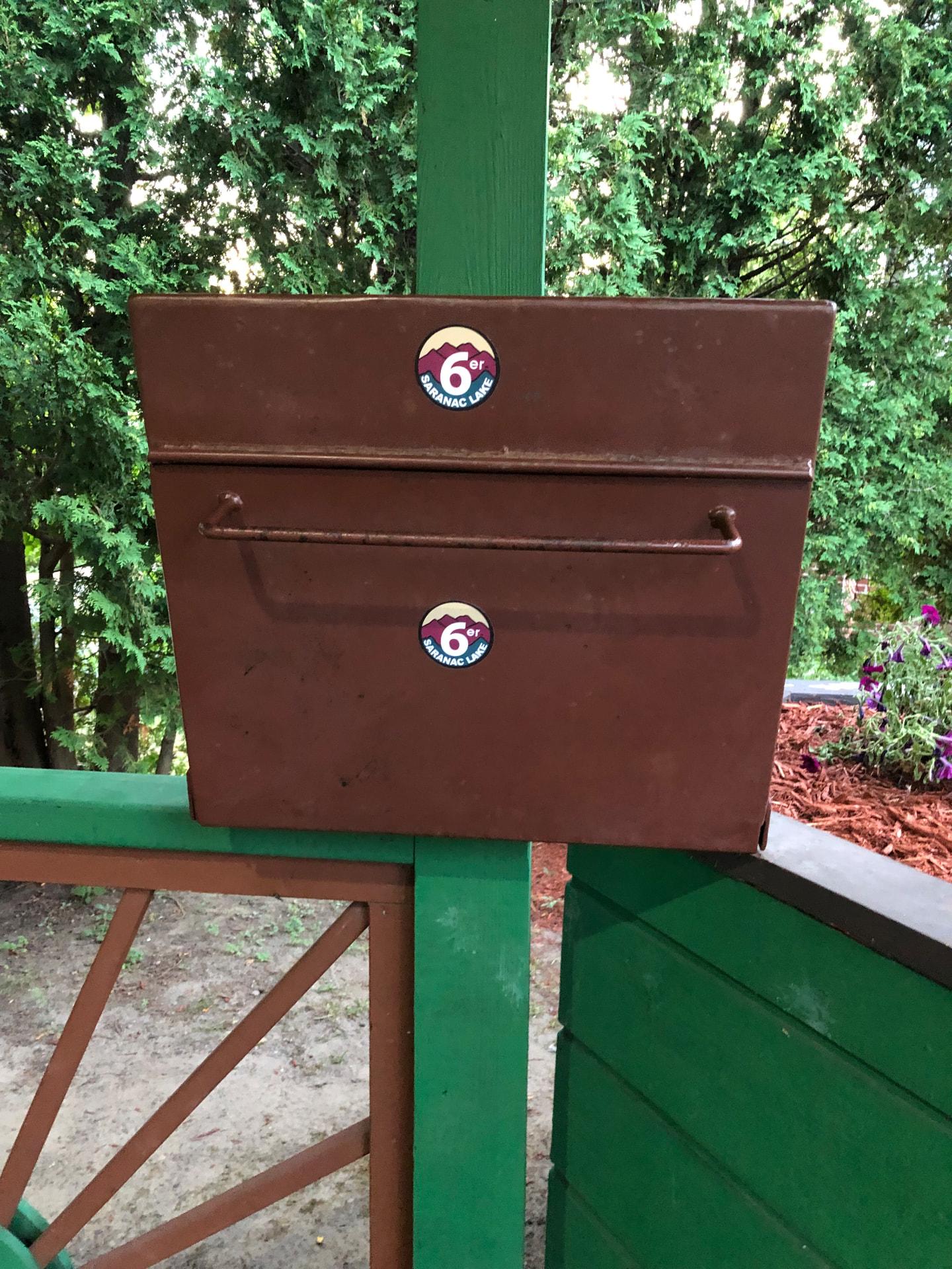 Saranac Lake 6er checkpoint box covered in stickers